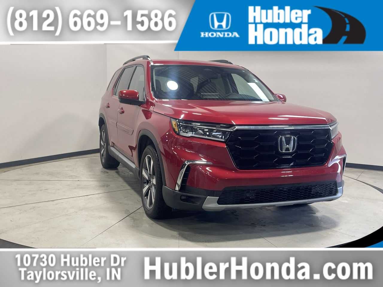 2024 Honda Pilot Touring in Radiant Red Metallic II — front three-quarter view