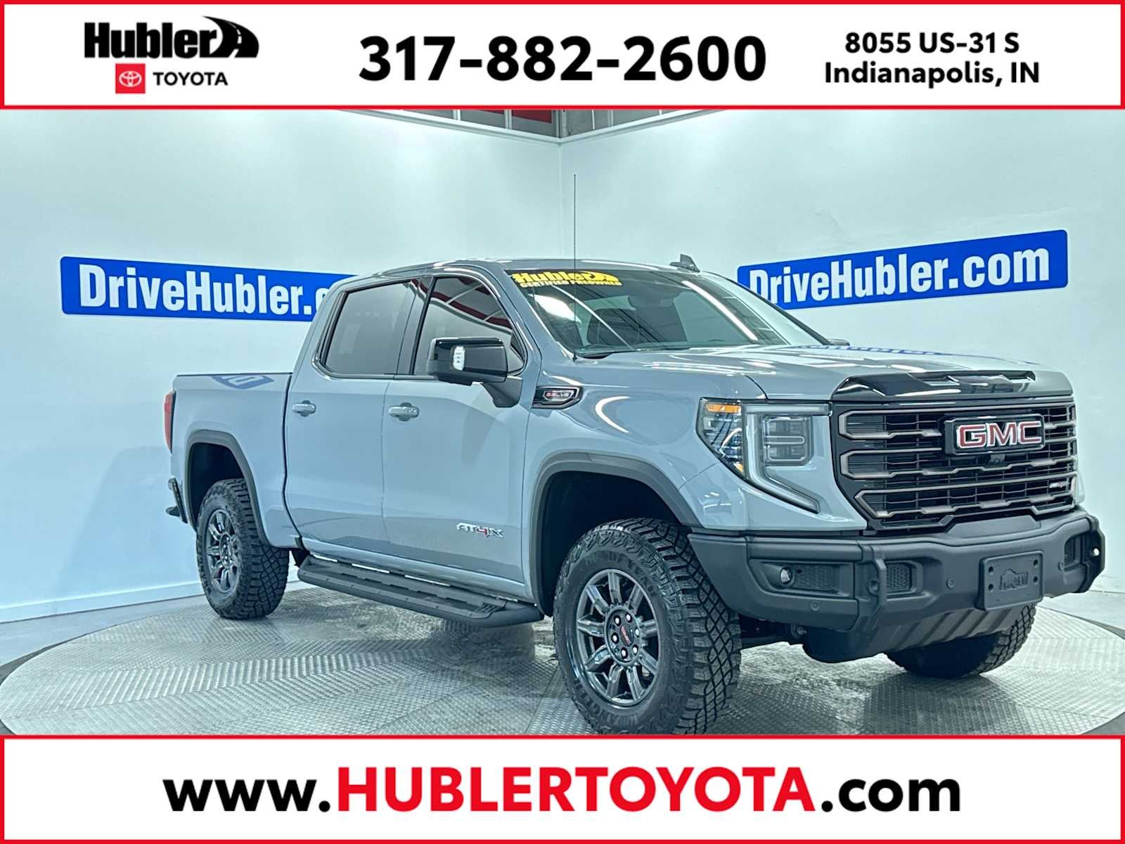 2024 GMC Sierra 1500 AT4X in Thunderstorm Gray — front three-quarter view