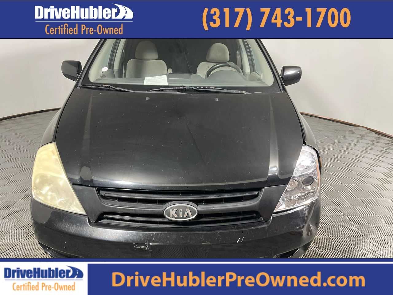 2009 Kia Sedona LX in Midnight Black — front three-quarter view